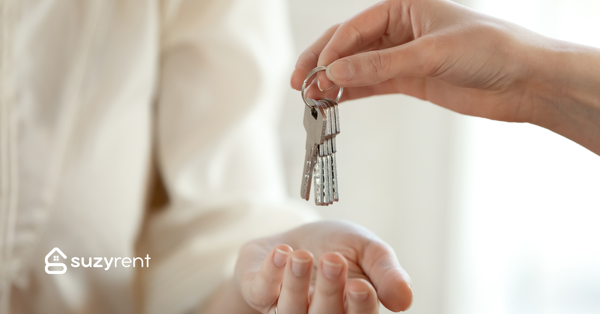 hand receiving key to a suzy rent property
